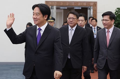 Taiwan's President Lai Ching-te (L) waves at Taoyuan International Airport in Taoyuan on November 30, 2024 before his trip to visit Taiwan's allies in the Pacific. Lai will leave on November 30 on a week-long tour of the Pacific that includes a stopover in Hawaii, which has ignited fiery threats from Beijing.