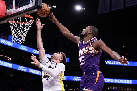 PHOENIX, ARIZONA - NOVEMBER 30: Kevin Durant #35 of the Phoenix Suns blocks a layup attempt by Pat Spencer #61 of the Golden State Warriors during the second half at Footprint Center in Phoenix, Arizona.