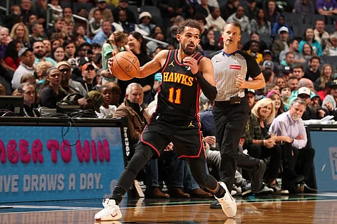 CHARLOTTE, NC - 30 NOVEMBER: Trae Young #11 of the Atlanta Hawks dribbles the ball during the game against the Charlotte Hornets at Spectrum Center in Charlotte, North Carolina.