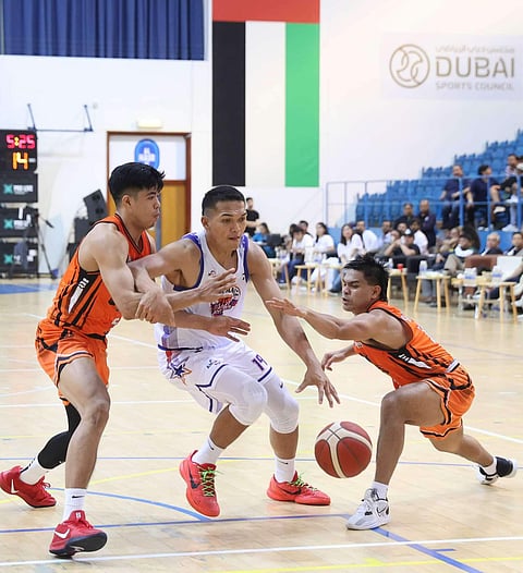 Justine Baltazar of Pampanga penetrates the defense of Ximone Sandagon and L-Jay Gonzales of Quezon Province during Game 2 of their MPBL Sixth Season National Finals best-of-five series late Tuesday in Dubai. The Giant Lanterns prevailed, 79-60.
