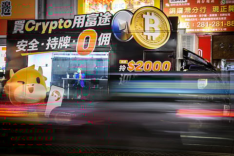 Bitcoin exchange advertisement truck in Hong Kong passes by as the cryptocurrency burst past $100,000 for the first time on 4 December as traders welcomed Donald Trump’s pick to head the US securities commission.