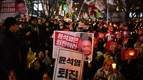 People take part in a candlelight vigil as they call for the resignation of South Korea President Yoon Suk Yeol