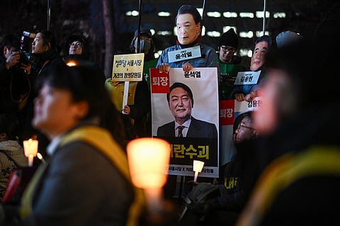 People take part in a protest calling for the ouster of South Korea President Yoon Suk Yeol outside the National Assembly in Seoul on 6 December, 2024. South Korea's ruling party chief demanded on 6 December that Yoon be stripped of office, warning there was a "significant risk" he could try to impose martial law again.