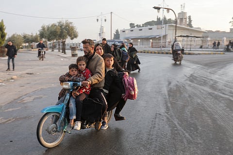 Displaced Syrians drive through Khan Shaykhun town as they evacuate northward to flee confrontation areas in the Hama governorate. Islamist-led rebels captured the central Syrian city of Hama on 5 December, days after seizing the country’s commercial hub Aleppo in a lightning offensive against President Bashar al-Assad’s forces.