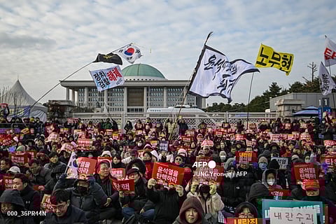 LOOK: People take part in a protest calling for the ouster of South Korea President Yoon Suk Yeol outside the National Assembly in Seoul on 7 December 2024. South Korea's embattled President Yoon Suk Yeol apologised but stopped short of resigning on December 7 over his declaration of martial law, as protesters gathered outside parliament ahead of a crucial impeachment vote that could decide his political fate.