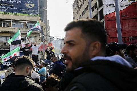 Syrian and Lebanese people celebrate the fall of the Syrian regime on 8 December, 2024, in the northern Lebanese city of Tripoli, after the Syrian capital Damascus fell into the hands of anti-government fighters. Islamist-led rebels declared that they have taken Damascus in a lightning offensive on December 8, sending President Bashar al-Assad fleeing and ending five decades of Baath rule in Syria.
