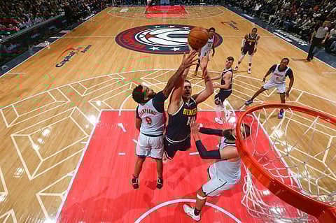 WASHINGTON, DC - 7 DECEMBER: Nikola Jokic #15 of the Denver Nuggets drives to the basket during the game against the Washington Wizards at Capital One Arena in Washington, DC.