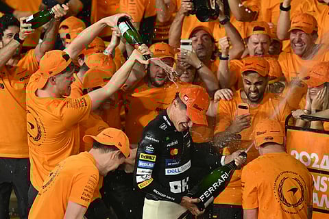 LANDO Norris gets a victory shower after helping McLaren win its first team title in 26 years following a victorious performance in the Abu Dhabi Grand Prix.
