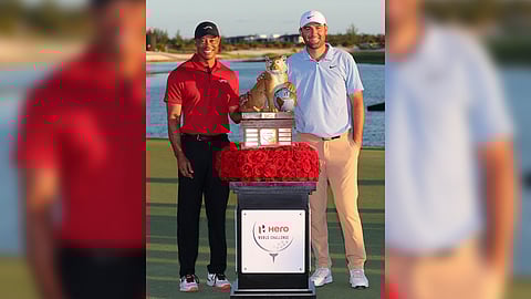 TOURNAMENT organizer Tiger Woods (left) presents the trophy to Scottie Scheffler following his impressive performance in the Hero World Challenge in the Bahamas.