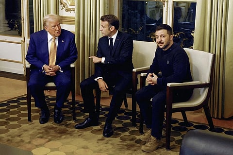 France’s President Emmanuel Macron (C), US president-elect Donald Trump (L) and Ukraine’s President Volodymyr Zelensky wait to pose before a meeting at The Elysee Presidential Palace in Paris on December 7, 2024.