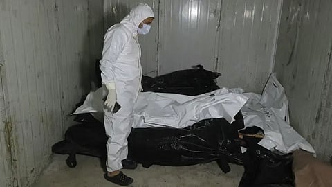 A sanitary serviceman stands by body bags at the morgue of a hospital in Damascus on December 10, 2024.