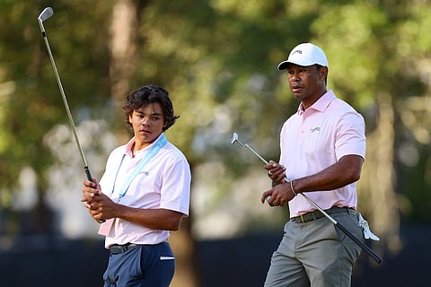 PINEHURST, NORTH CAROLINA - JUNE 11: Tiger Woods of the United States and his son, Charlie Woods, look on from the second hole during a practice round prior to the U.S. Open at Pinehurst Resort on June 11, 2024 in Pinehurst, North Carolina.