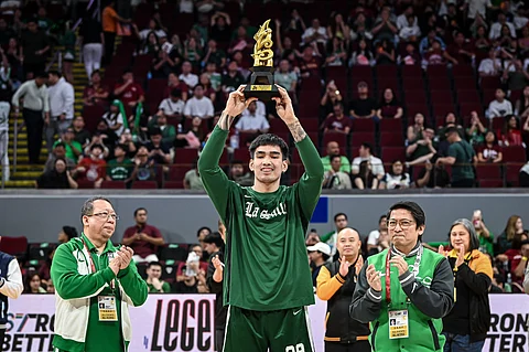 Kevin Quiambao of La Salle raises the trophy after emerging as Most Valuable Player of Season 87 UAAP men’s basketball tournament.