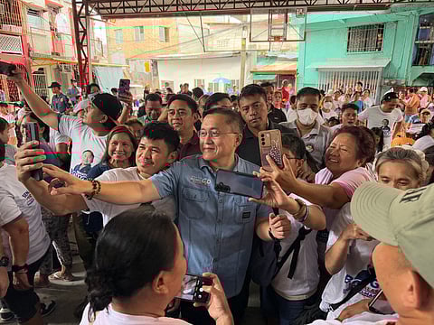 Senator Christopher "Bong" Go poses for selfies with the citizens of Taguig City, during his visit on Wednesday, 11 December 2024.
