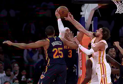 Josh Hart #3 of the New York Knicks tries to pass as Trae Young #11 of the Atlanta Hawks defends during the second half of the quarterfinal game of the Emirates NBA Cup at Madison Square Garden on December 11, 2024 in New York City. The Atlanta Hawks defeated the New York Knicks 108-100 to advance to the semifinal round.