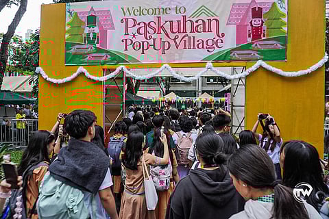 The UST Paskuhan Pop Up Village welcoming students to the bazaar.