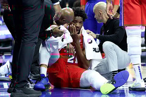 Joel Embiid gets attended to by the Philadelphia 76ers personnel after accidentally being struck by an elbow against the Indiana in their NBA regular season game Friday won by the Pacers, 121-107.