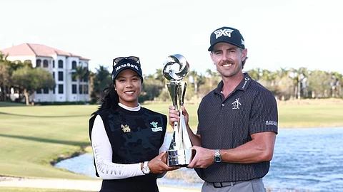 Patty Tavatanakit of Thailand and Jake Knapp of the United States pose with the trophy after winning the Grant Thornton Invitational pairs event featuring LPGA and PGA players
