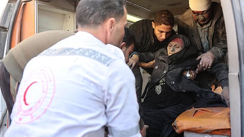 Paramedics put a wounded Palestinian woman into an ambulance before transporting her to a hospital in Gaza City on December 15, 2024.