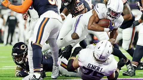 Aaron Jones of the Minnesota Vikings scores a third quarter touchdown in the Vikings' NFL victory over the Chicago Bears