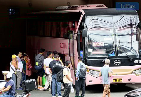 Passengers arrive at Quezon City's provincial bus terminal on Saturday, 21 December, 2024, to catch buses heading to their home provinces for Christmas.