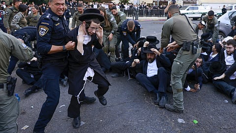 Israeli security personnel in Jerusalem disperse ultra-Orthodox Jewish protesters opposed to conscription, on October 31, 2024