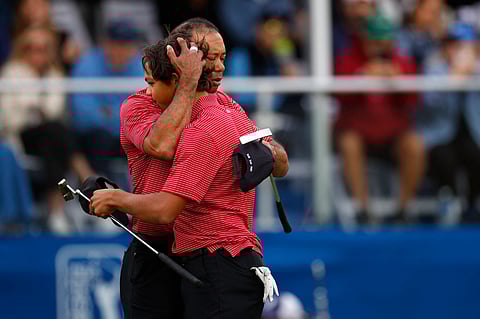 TIGER Woods hugs his son, Charlie, after bowing to Bernard and Jason Langer in the playoff for the PNC Championship family golf event crown over the weekend.