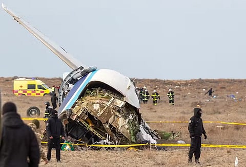 Emergency specialists work at the crash site of an Azerbaijan Airlines passenger jet near the western Kazakh city of Aktau on December 25, 2024.