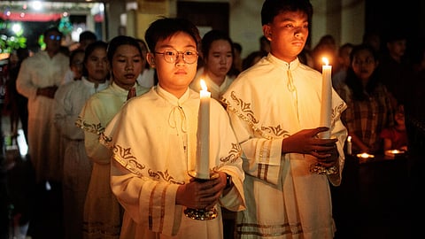 Catholic candle bearers take part in a Christmas Eve mass in Indonesia's Aceh
