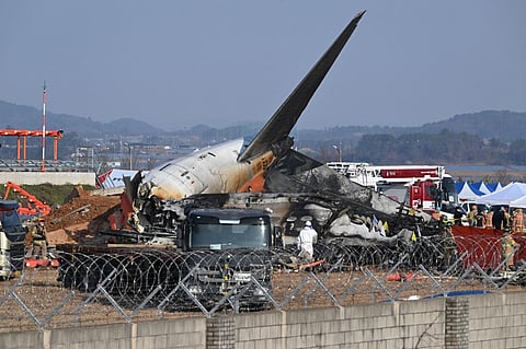 Firefighters and rescue personnel at the Jeju Air Boeing 737-800 crash scene at Muan International Airport in South Jeolla Province, 288 kilometers southwest of Seoul, on 29 December 2024. The plane, carrying 181 passengers from Bangkok to South Korea, crashed upon arrival, colliding with a barrier and bursting into flames.