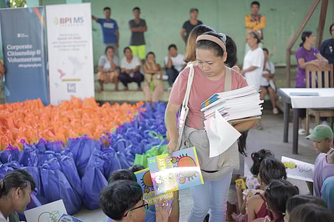 Ayala Foundation volunteers distribute coloring books to children of typhoon ‘Kristine’ evacuees in Albay.