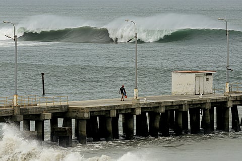 MAN walks on a dock as tidal waves are seen in Lobitos, Talara Province, Peru, on 27 December 2024. On 28 December, Peru raised to 91 the number of ports closed, out of a total of 121, and restricted access to recreational beaches as heavy waves hit the northern and central coast of the country, authorities said.