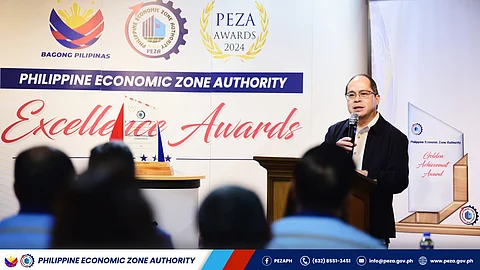 PEZA director general Tereso Panga addresses the awardees of various commendations as they cap the year extolling outstanding PEZA locators recently.
