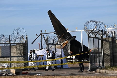 Recovery teams work at the scene where a Jeju Air Boeing 737-800 series aircraft crashed and burst into flames at Muan International Airport in Muan, some 288 kilometres southwest of Seoul on December 30, 2024. The Boeing 737-800 was carrying 181 people from Thailand to South Korea when it crashed on arrival on December 29, killing everyone aboard -- save two flight attendants pulled from the twisted wreckage of the worst aviation disaster on South Korean soil.