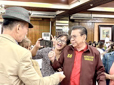 Senatorial candidate Luis 'Manong Chavit' Singson poses for a selfie with a barangay official during a meet-and-greet event at a hotel in Quezon City.