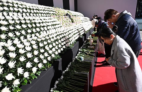 Mourners pay their respects at a memorial altar for the victims of the Jeju Air plane crash, in front of Seoul City Hall in Seoul on 31 December, 2024. The Boeing 737-800 was carrying 181 people from Thailand to South Korea when it crashed on arrival on 29 December, killing everyone aboard -- save two flight attendants pulled from the twisted wreckage of the worst aviation disaster on South Korean soil.