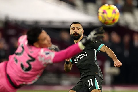 Liverpool's Egyptian striker #11 Mohamed Salah looks on as West Ham United's French goalkeeper #23 Alphonse Areola saves his shot during the English Premier League football match between West Ham United and Liverpool at the London Stadium, in London on 39 December, 2024.