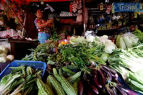 Vendors arrange vegetables for sale in Tandangsora, Quezon City, along Commonwealth Avenue on Thursday. The Asian Development Bank forecasts inflation to drop to 3.2 percent in 2025, down from its previous estimate of 3.4 percent.
