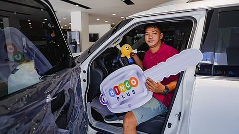 BingoPlus lucky winner from BP Day campaign posing inside his brand-new Nissan Patrol Royale.