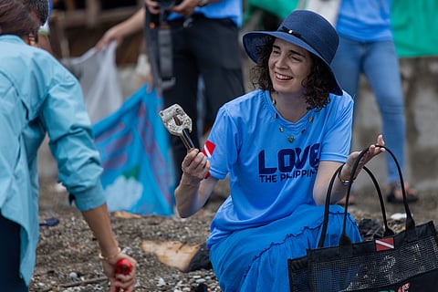 New Zealand Ambassador to the Philippines Catherine McIntosh picks up trash during the coastal clean-up in Anilao, Batangas on 29 November 2024, led by the Department of Tourism.