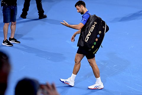 Novak Djokovic walks away after crashing out of Brisbane International following a 7-6 (8/6), 6-3 loss to Reilly Opelka in the quarterfinals of the men’s singles event.