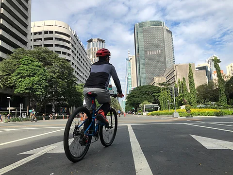 A cyclist cruises along Ayala Avenue, now a peaceful stretch for bikers and joggers on a car-free Sunday.