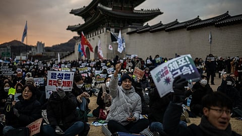 People chant slogans during a rally held to protest against impeached South Korea's president Yoon Suk Yeol in front of the Gwanghwamun Gate in Seoul on January 4, 2025.