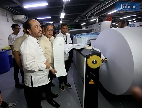 Comelec chairman George Erwin Garcia holds a ballot printed during a 6 January tour of the National Printing Office in Quezon City.