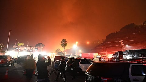 A ferocious wildfire in a Los Angeles suburb devoured buildings and sparked panicked evacuations January 7, as hurricane-force winds tore through the region.