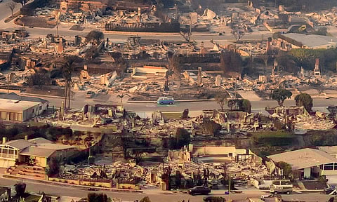 In this aerial view taken from a helicopter, burned homes are seen from above during the Palisades fire near the Pacific Palisades neighborhood of Los Angeles, California on 9 January 2025. Massive wildfires that engulfed whole neighborhoods and displaced thousands in Los Angeles remained totally uncontained 9 January, 2025, authorities said, as US National Guard soldiers readied to hit the streets to help quell disorder. Swaths of the United States' second-largest city lay in ruins, with smoke blanketing the sky and an acrid smell pervading almost every building.