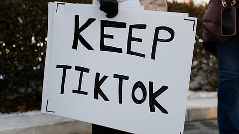 WASHINGTON, DC - 10 JANUARY: A TikTok influencer holds a sign that reads "Keep TikTok" outside the U.S. Supreme Court Building as the court hears oral arguments on whether to overturn or delay a law that could lead to a ban of TikTok in the U.S., on 10 January 2025 in Washington, DC. The future of the popular social media platform is at stake as the Supreme Court hears arguments on a law set to take effect the day before Inauguration Day that would force their China-based parent company to cut ties with TikTok due to national security concerns.