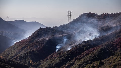 Wildfire smoke and hotspots from the Palisades fire area seen from Encino Hill on 12 January 2025 in Encino neighborhood of Los Angeles, California. Multiple wildfires fueled by intense Santa Ana Winds are still burning across Los Angeles County while some containment has been achieved. At least 16 people have died and over 100,000 people are still under evacuation orders. Over 12,000 structures have been destroyed in the fires.