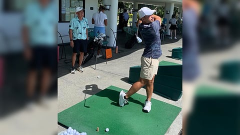 With coach Toch Altea watching behind, Miguel Tabuena hits balls on the range ahead of his campaign in the Philippine Open at the Manila Southwoods Golf and Country Club in Carmona, Cavite on Friday.