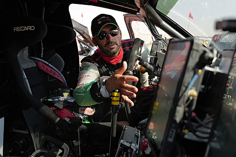 Yazeed al-Rajhi checks his car as he waits at the start of Stage 11 of the Dakar Rally 2025.